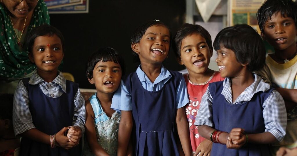 This shows the holistic development in education. Some students are standing outside the class.they are talking. All are very happy.
