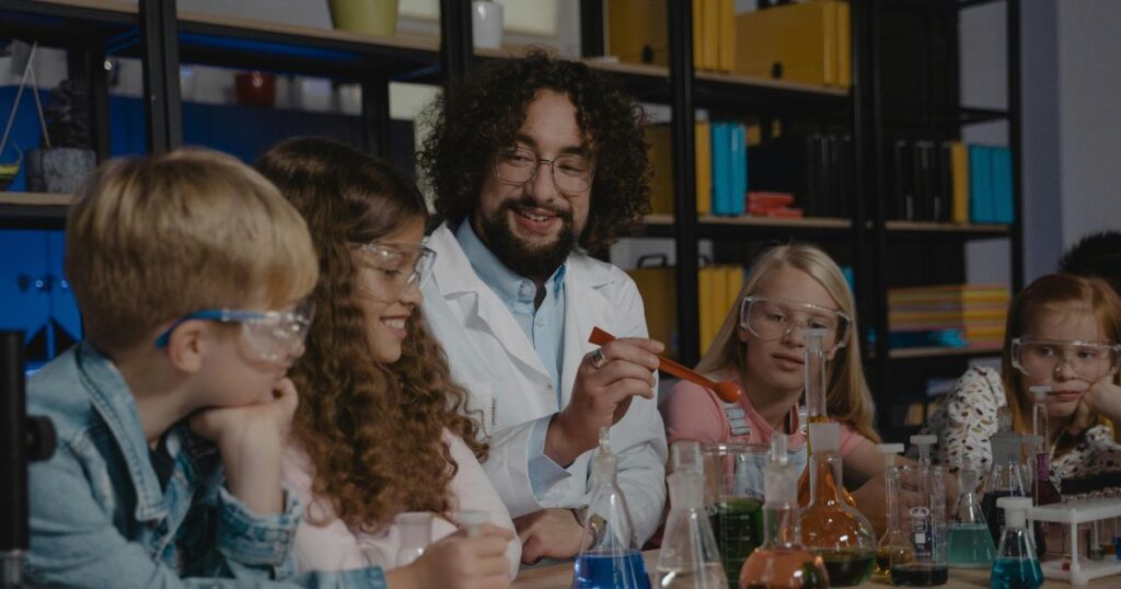 A teacher is explaining something to his students in a lab. It is a result of motivational factors in learning