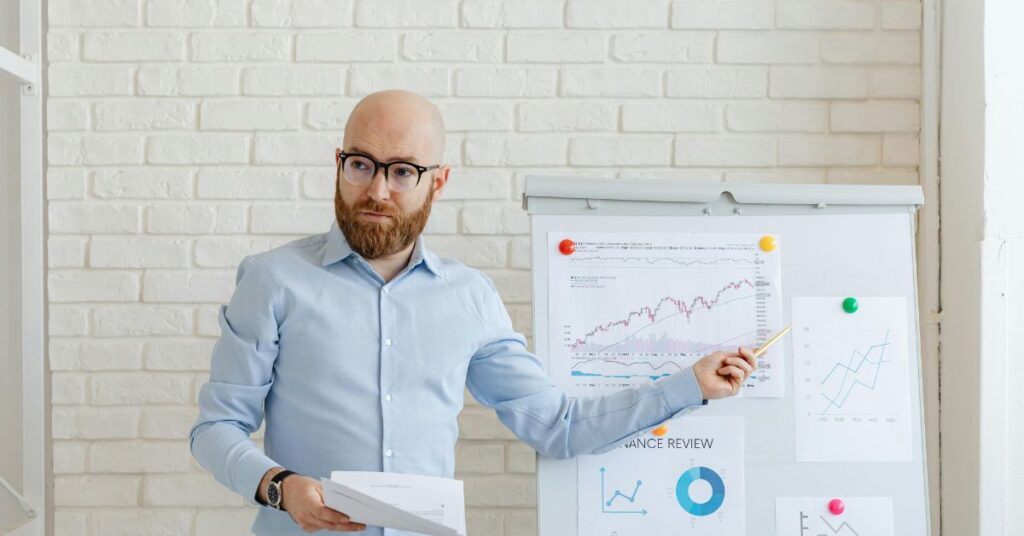 A great teacher is explaining something to his staff about school activities.What makes a great school principal