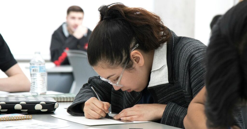 Assessment in education. A girl is writing the exam.